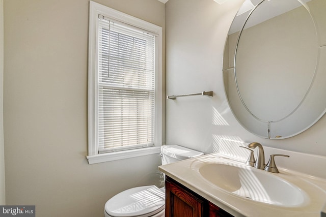 half bathroom featuring toilet and vanity