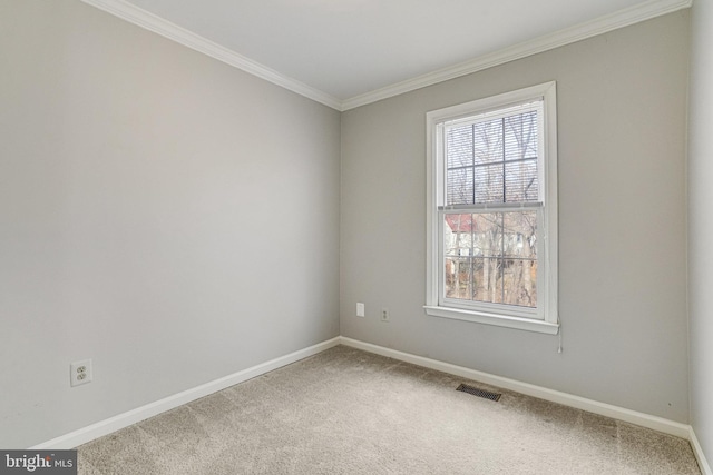 carpeted empty room featuring visible vents, crown molding, and baseboards