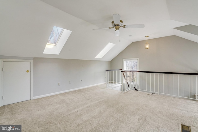 additional living space with carpet, visible vents, vaulted ceiling, and baseboards