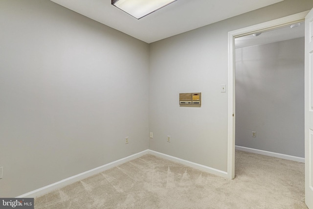 empty room with light carpet and baseboards