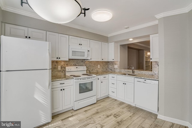 kitchen featuring white appliances, a sink, white cabinets, backsplash, and crown molding