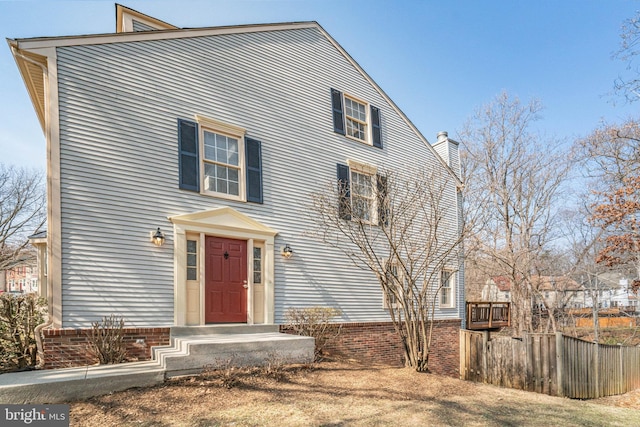 view of front of home featuring fence