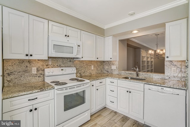 kitchen featuring an inviting chandelier, ornamental molding, white cabinetry, a sink, and white appliances