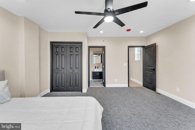 bedroom with carpet floors, recessed lighting, a closet, ensuite bath, and baseboards