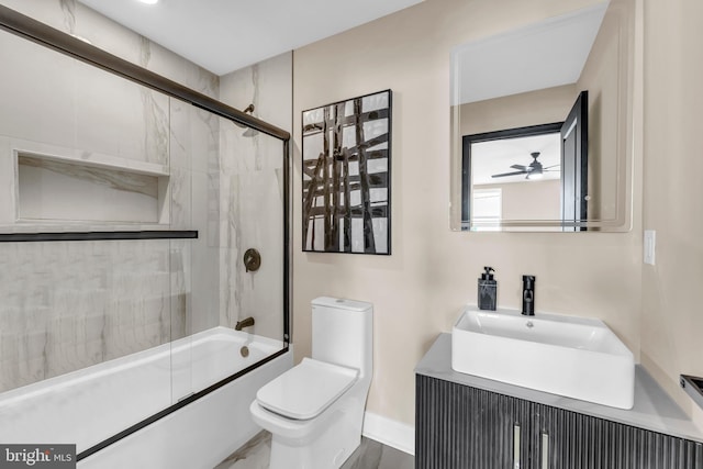 full bath featuring enclosed tub / shower combo, vanity, and toilet