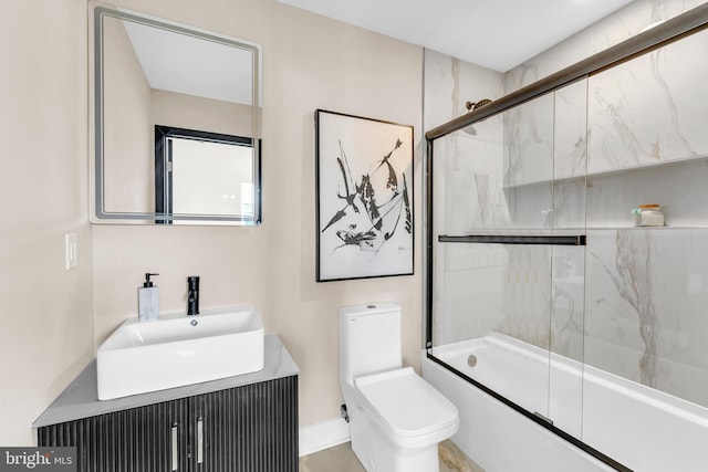 full bathroom with vanity, toilet, and bath / shower combo with glass door