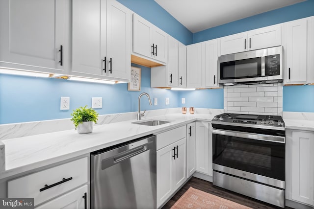 kitchen featuring white cabinetry, stainless steel appliances, and a sink