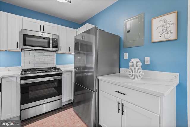 kitchen featuring white cabinets, electric panel, and stainless steel appliances