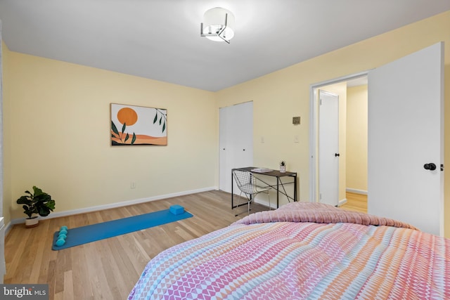 bedroom with baseboards and wood finished floors