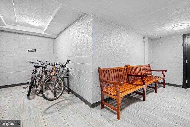 interior space with concrete block wall and baseboards