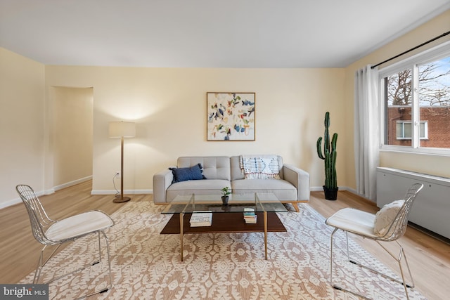 living area with wood finished floors and baseboards