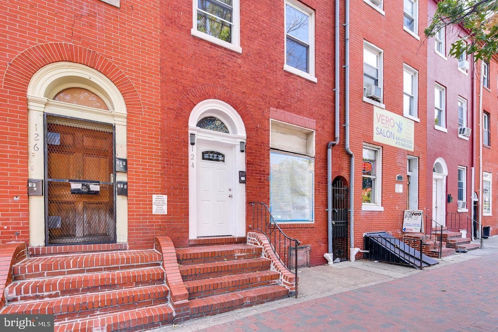 doorway to property with brick siding