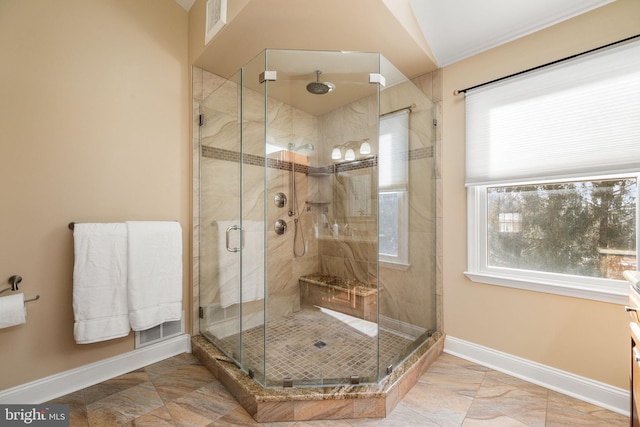 full bath featuring a shower stall and baseboards