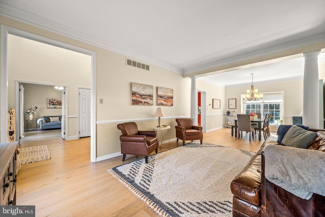 living area with light wood-type flooring, decorative columns, visible vents, and ornamental molding