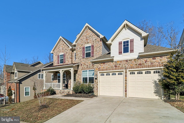 traditional-style house featuring a porch, a garage, stone siding, driveway, and roof with shingles