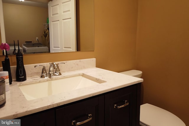 4136 E Capitol St NE, Washington, DC 20019 - bathroom with washer / dryer, toilet, and vanity