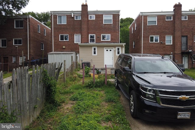 4136 E Capitol St NE, Washington, DC 20019 - rear view of property with a chimney, brick siding, and central air condition unit