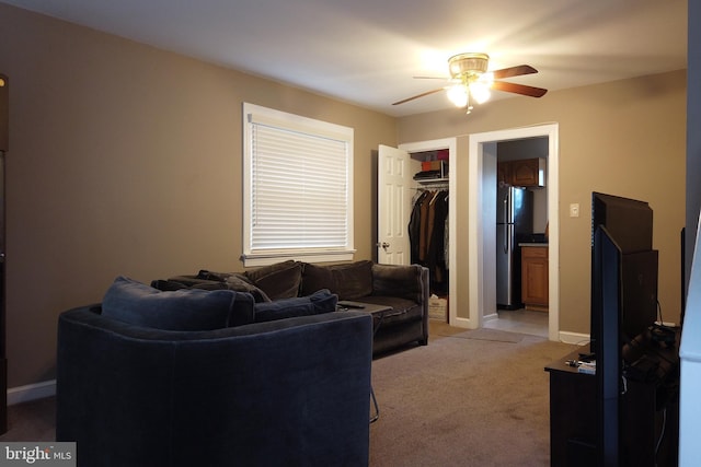 4136 E Capitol St NE, Washington, DC 20019 - living room featuring a ceiling fan, light colored carpet, and baseboards