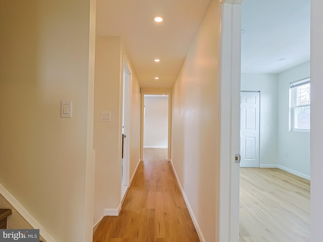 hall with recessed lighting, baseboards, and light wood finished floors