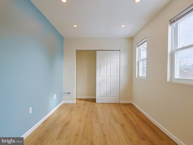 unfurnished bedroom with light wood-type flooring, baseboards, visible vents, and recessed lighting