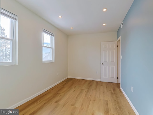 empty room featuring recessed lighting, baseboards, visible vents, and light wood finished floors