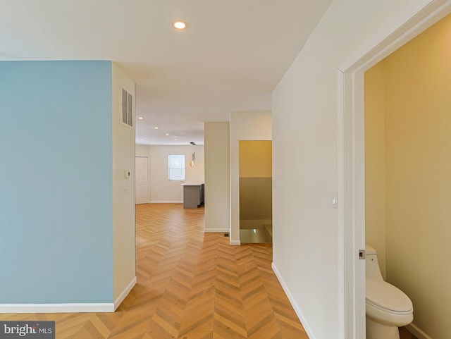 hallway with recessed lighting, visible vents, and baseboards