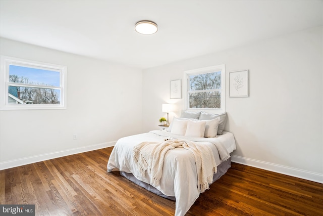 bedroom with baseboards and wood finished floors