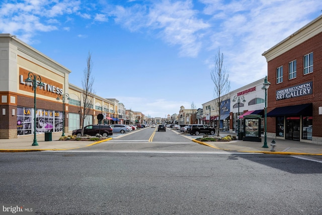 view of road featuring sidewalks, street lighting, and curbs