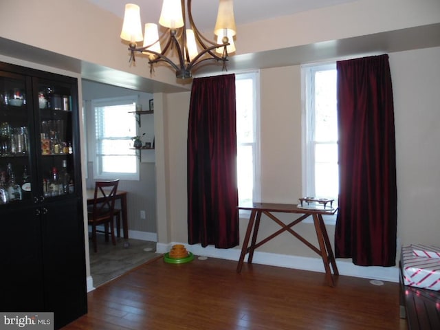 dining space with wood finished floors and baseboards