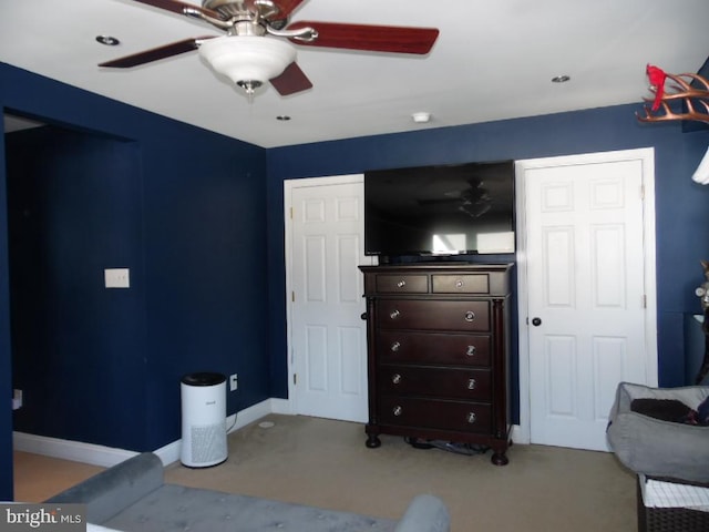 bedroom with ceiling fan, carpet, and baseboards