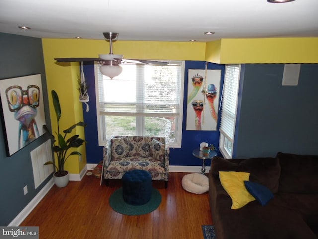 sitting room with baseboards and wood finished floors