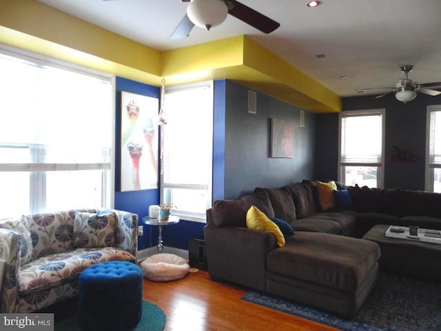 living area featuring ceiling fan, a wealth of natural light, and wood finished floors