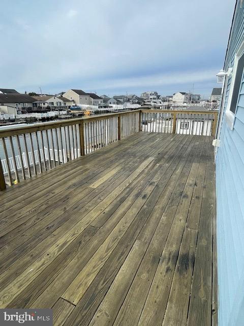 wooden terrace featuring a water view