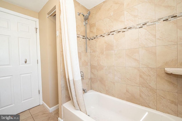 bathroom featuring shower / bath combo, tile patterned flooring, and baseboards