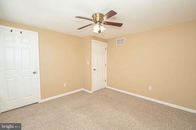 unfurnished bedroom with baseboards, visible vents, ceiling fan, and carpet flooring