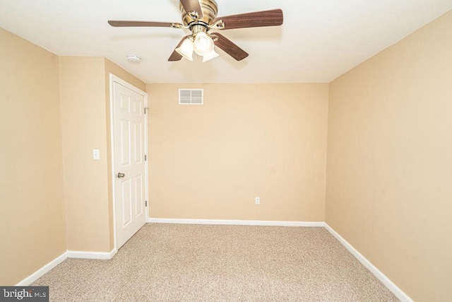 unfurnished room featuring baseboards, visible vents, ceiling fan, and light colored carpet