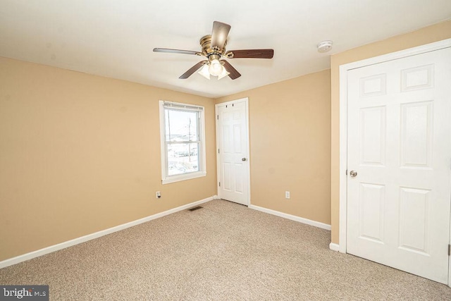 unfurnished bedroom with light carpet, ceiling fan, visible vents, and baseboards