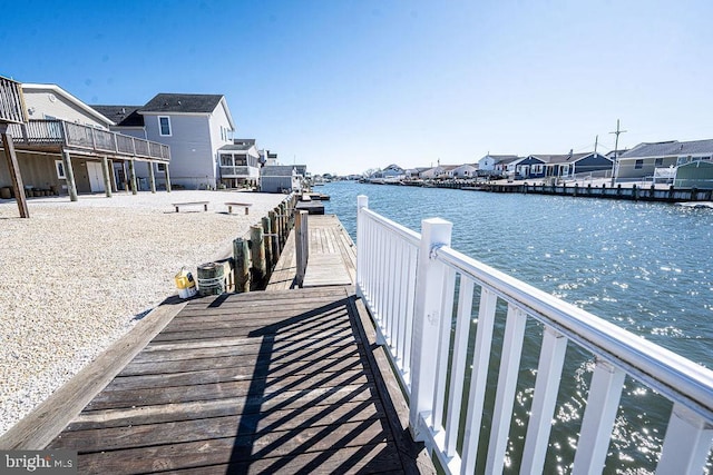 dock area featuring a residential view and a water view