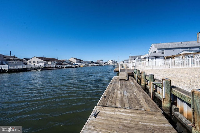 dock area featuring a residential view and a water view