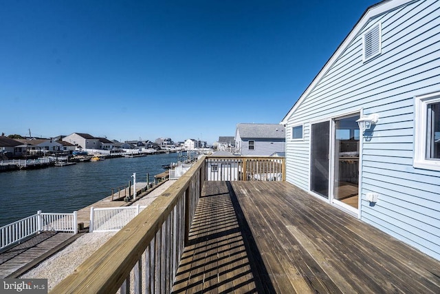 wooden deck featuring a water view