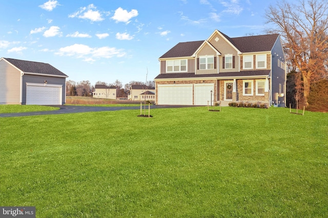 view of front of property featuring an attached garage, driveway, and a front yard