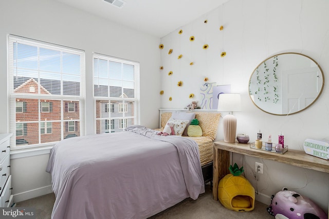bedroom featuring carpet floors, multiple windows, and baseboards