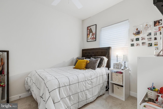 carpeted bedroom with baseboards and a ceiling fan