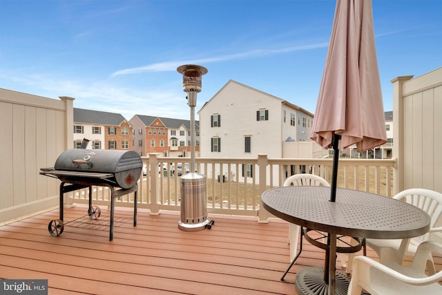 wooden terrace featuring a grill and a residential view