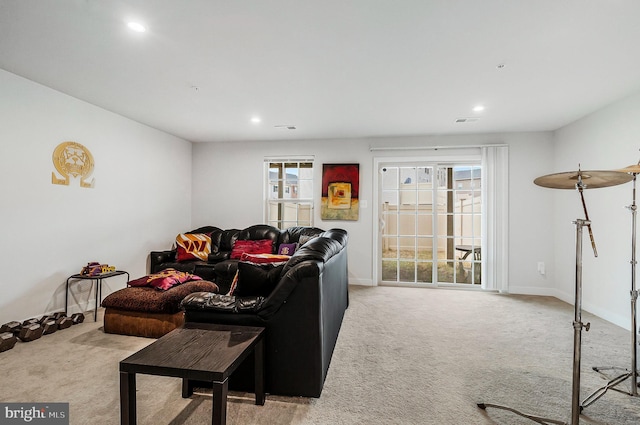 carpeted living room with recessed lighting, visible vents, and baseboards