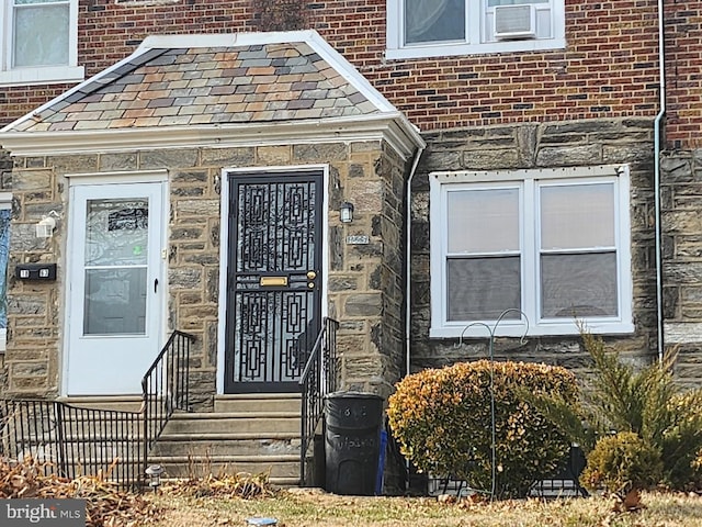 doorway to property featuring stone siding