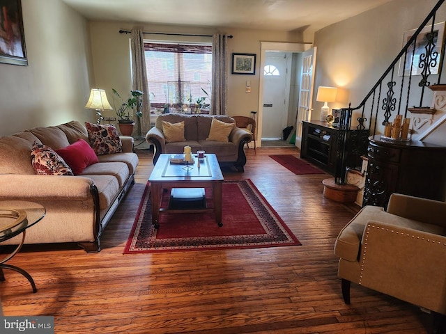 living area featuring stairway and wood finished floors