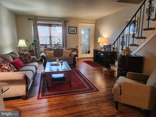 living area featuring stairs and wood finished floors