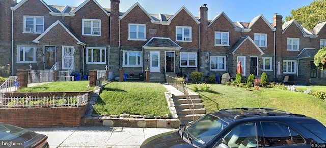 view of front of house with stone siding, a front lawn, and a residential view