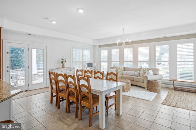 dining area with an inviting chandelier and light tile patterned floors